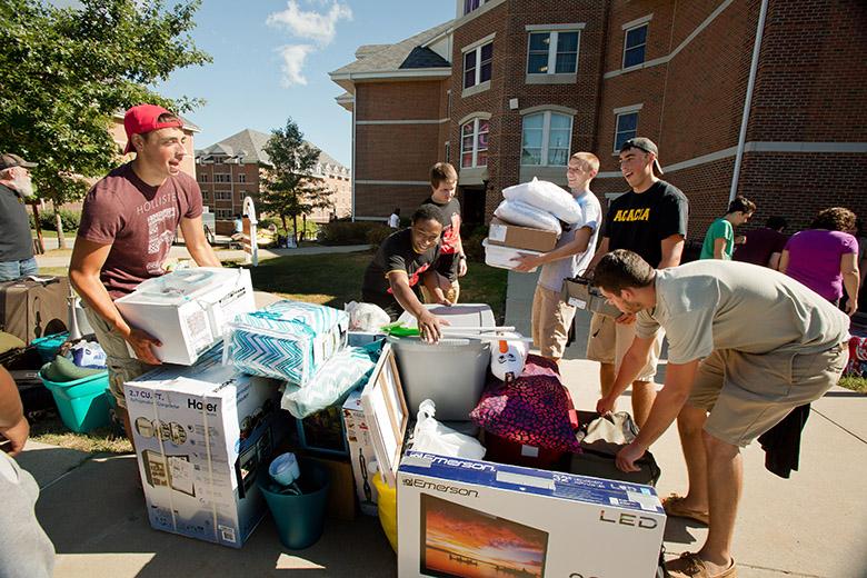 Members of Acacia and Tau Kappa Epsilon fraternities help move new students into the Cal U residence halls during the annual Move-In Day.