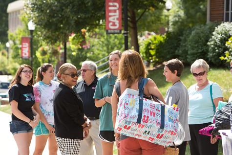 Taylor Shenk, a freshman from Carlisle, Pa., shares a light moment with Interim University President Geraldine Jones during the annual Move-In Day.