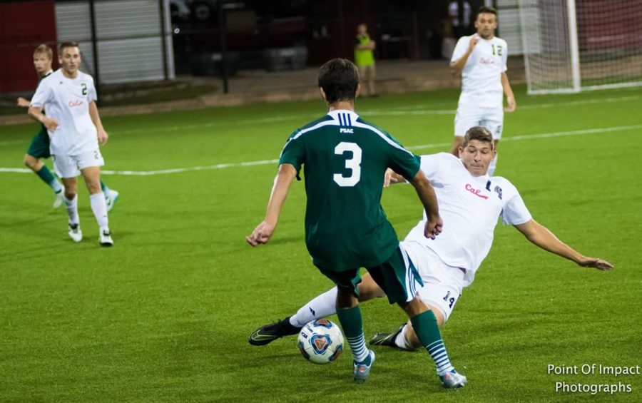 Brad Powell, 14, slide tackles a Slippery Rock player.