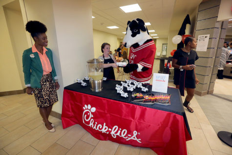 The marketing team hands out samples of lemonade as students wait in line for Chick-fil-A.