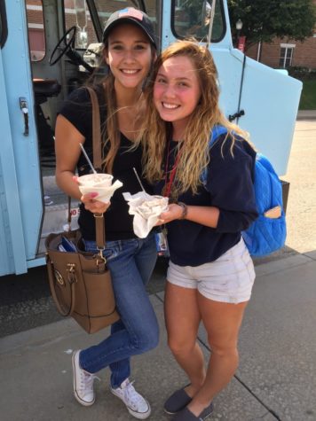 Two students enjoy their free ice cream.