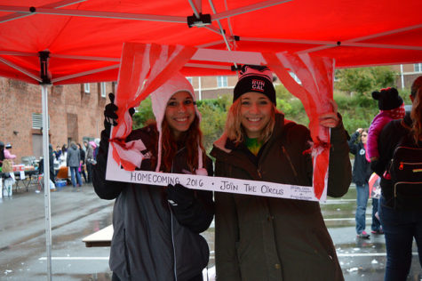 Lauren DiLuca and Christina Homer pose for a photo featuring this year's Homecoming frame.