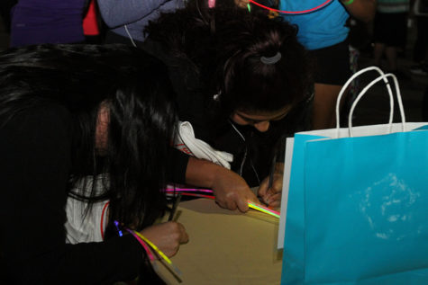 Two students fill out their raffle tickets in hopes of winning one of the prize packs.