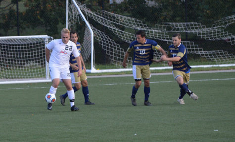 Senior, Nick Cichon, battles around three Pitt-Johnstown players.