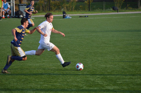 Elliot Taylor, senior, pushes up the field and past Pitt-Johnstown's defenders.