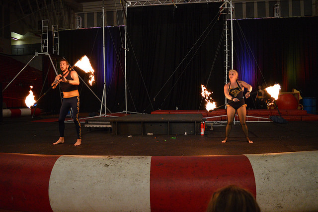 Two members of the Cincinnati Circus Company juggle fire.