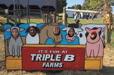 Students mess around with the photo props at Triple B Farms.