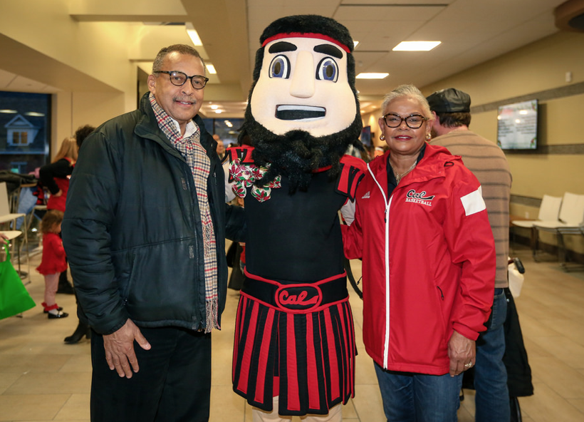 President Jones and her husband stand with Blaze at the second annual Holly Day.