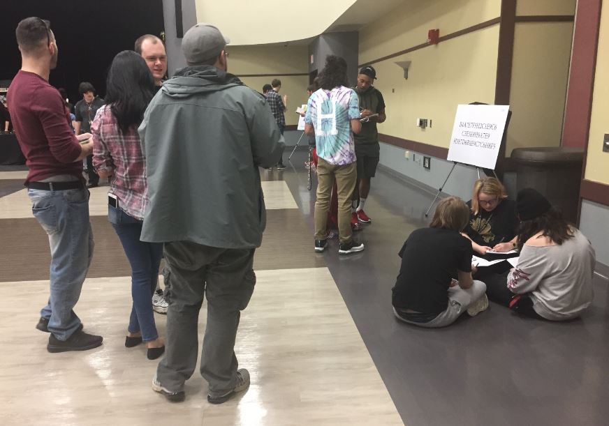 Students sit down and try to put all of the clues together during the Escape Room event.