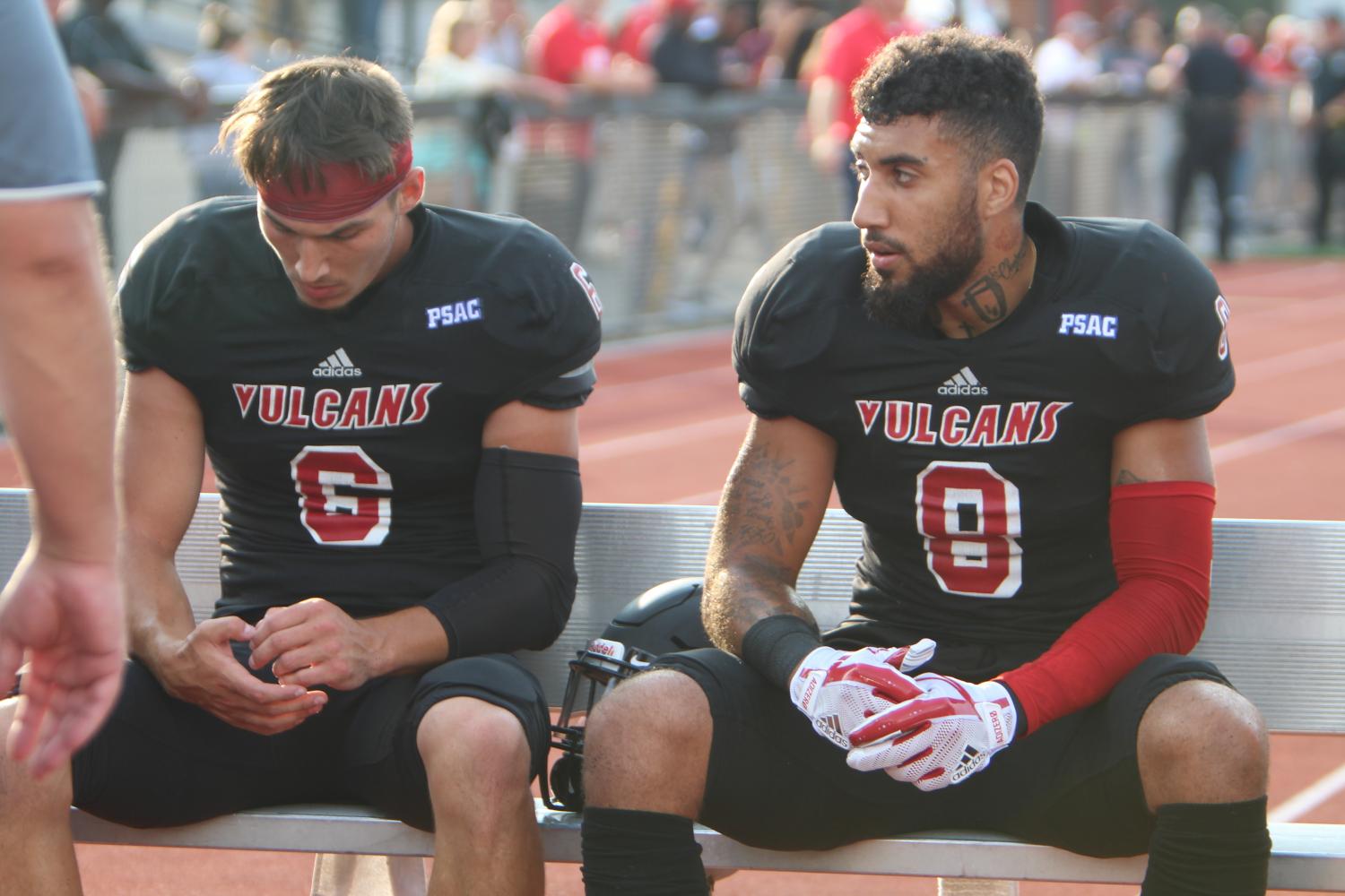 Luke Smorey (6) and Tom Greene (8) talk on the sidelines at Adamson Stadium on August 31. Smorey and Greene are both senior wide receivers.