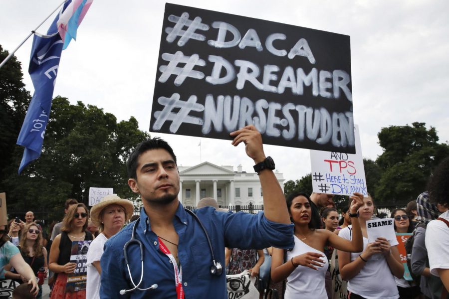 Carlos Esteban, 31, of Woodbridge, Virginia, a nursing student and recipient of Deferred Action for Childhood Arrivals, known as DACA, rallies with others in support of DACA outside of the White House Tuesday. Photo by Jacquelyn Martin/Associated Press.