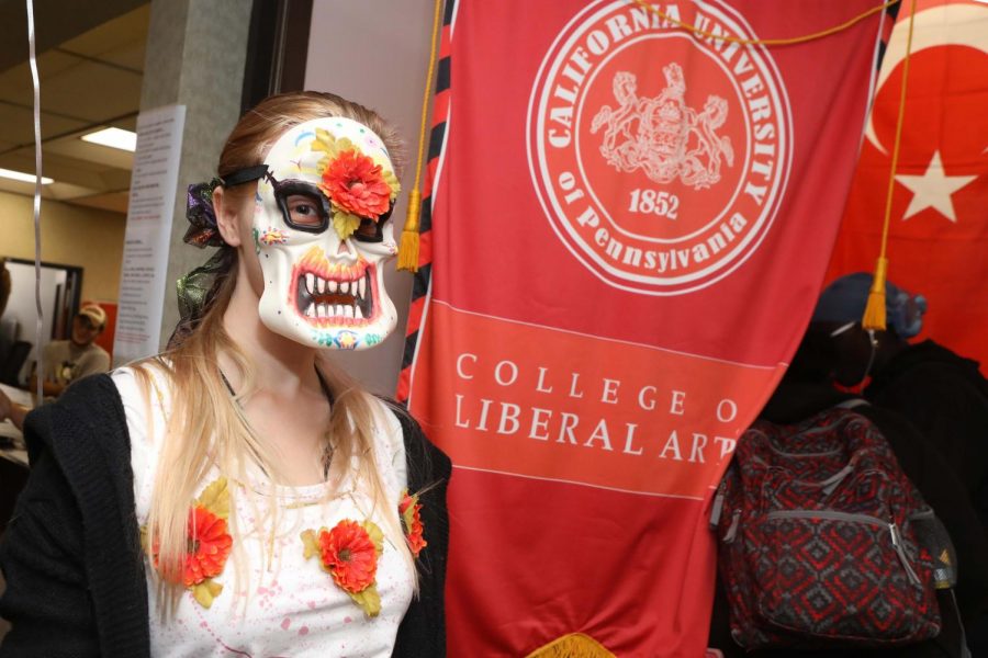 (Oct. 2, 2018) Amber Meister, sophomore, wears a mask depicting Mexican culture “Day of the Dead” and pagan holiday for  “All Hallows Eve at the Cal U Liberal Arts Festival, Manderino Library, at California University of Pennsylvania.
