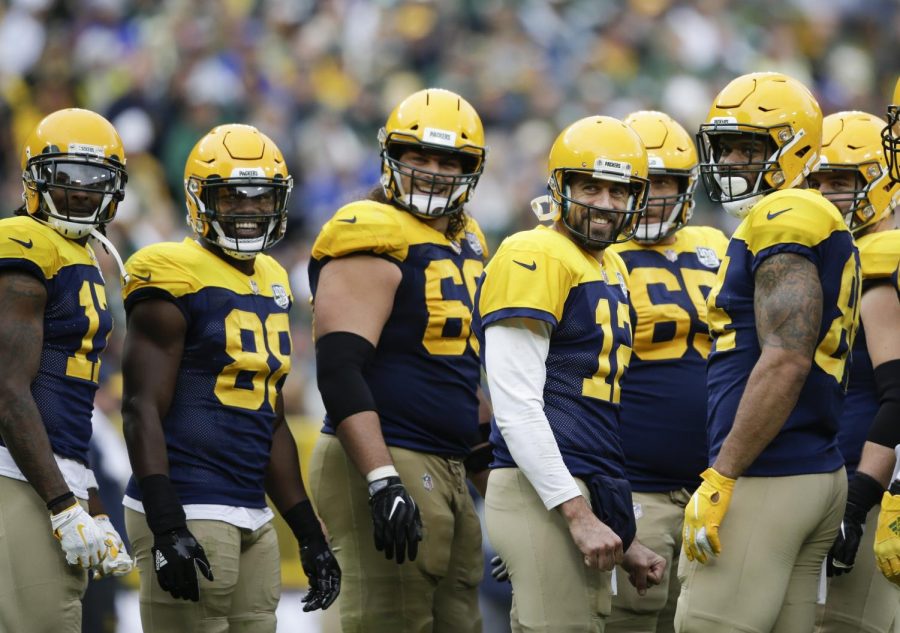 Green Bay Packers Aaron Rodgers and teammates smile at fans during a break in the second half of an NFL football game Sunday, Sept. 30, 2018, in Green Bay, Wis. The Packers won 22-0. (AP Photo/Jeffrey Phelps)