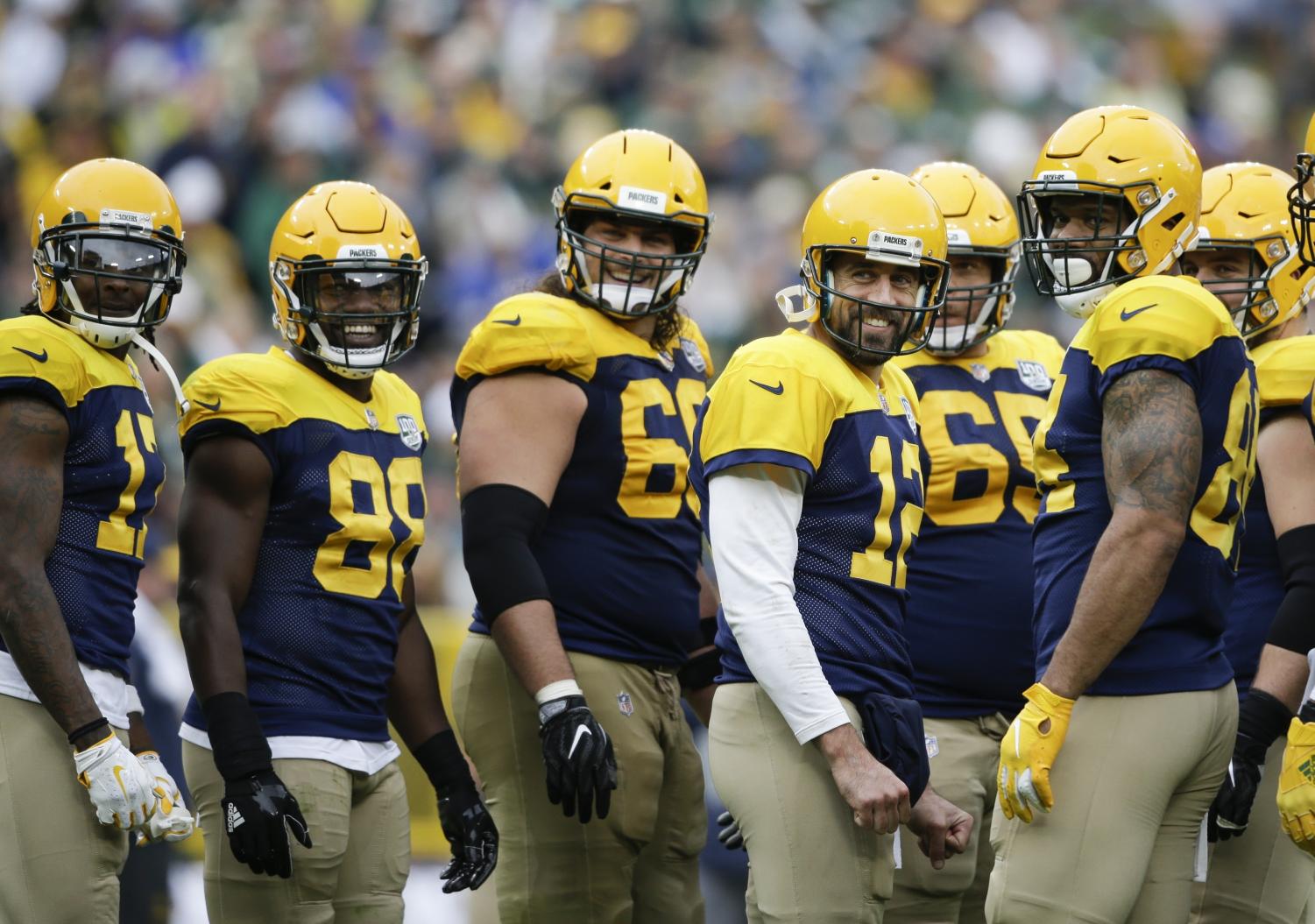 Green Bay Packers' Aaron Rodgers and teammates smile at fans during a break in the second half of an NFL football game Sunday, Sept. 30, 2018, in Green Bay, Wis. The Packers won 22-0. (AP Photo/Jeffrey Phelps)