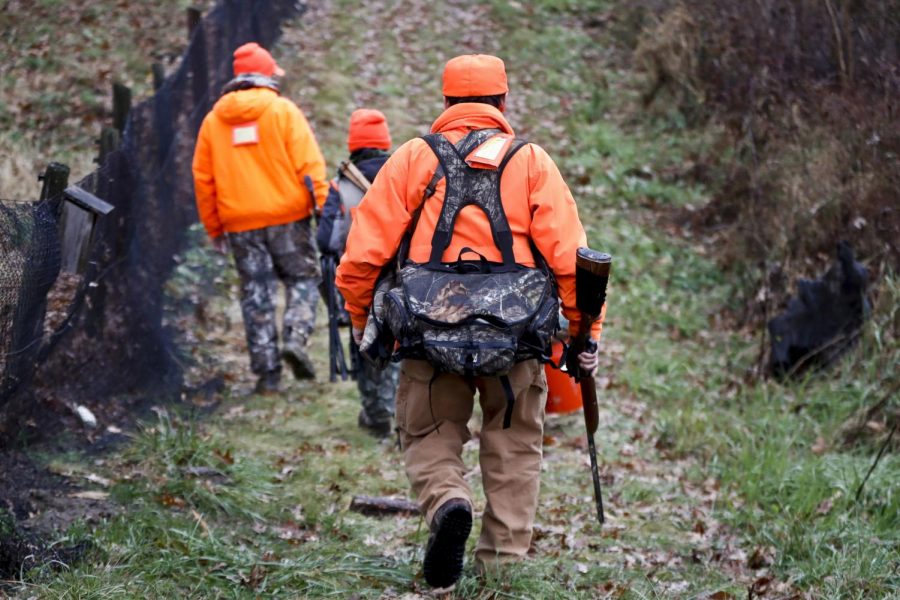 Santo Cerminaro, right, follows his son, Dominick Cerminaro, left, and grandson, Santo Cerminaro, 11, into the woods to go deer hunting on the first day of regular firearms deer hunting season, in most of Pennsylvania, Monday, Nov. 26, 2018 in Zelienople, Pa.