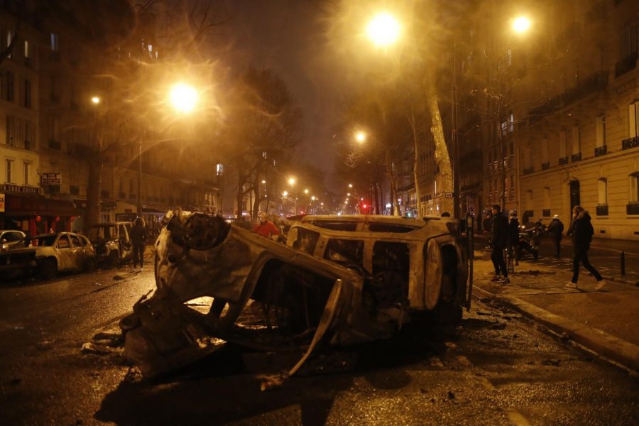 Charred cars are pictured after a demonstration Saturday, Dec.1, 2018 in Paris. A protest against rising taxes and the high cost of living turned into a riot Saturday in Paris as police fired tear gas and water cannon in street battles with activists wearing the fluorescent yellow vests of a new movement.