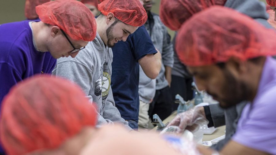 Mike Bordonaro, a sophomore athletic training major from New Kensington, works a table with other students sealing bags that had been packed with rice, soy beans, vegetables, and vitamin packets. The meal-preparation event was held Wednesday, November 14 in the Natali Performance Center, where several dozen students packed 10,000 meals into boxes to be distributed globally.