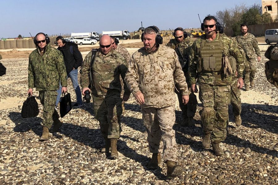 Gen. Frank McKenzie, center front, the top U.S. commander for the Middle East, walks as he visits a military outpost in Syria, Saturday, Jan. 25, 2020. McKenzie made the unannounced visit to Syria, traveling to five different military outposts to meet with troops, hear from commanders and talk with the leader of the Syrian Democratic Forces. (AP Photo/Lolita Baldor)