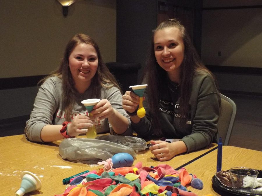 Breal Savage and Kaydee Taylor fill balloons with flour to make stress balls for Special Olympic athletes. 