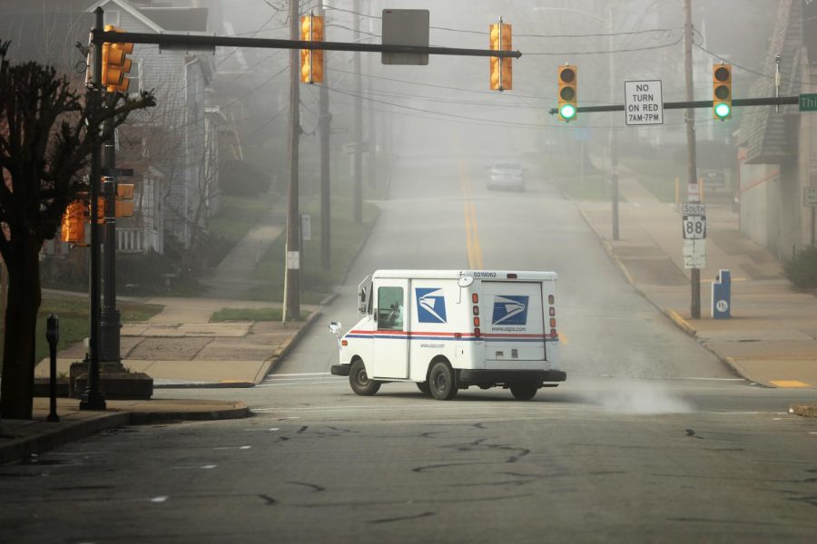 A U.S. Postal Service truck at the intersection of Third and Wood Street, California, Pa.  March 26, 2020