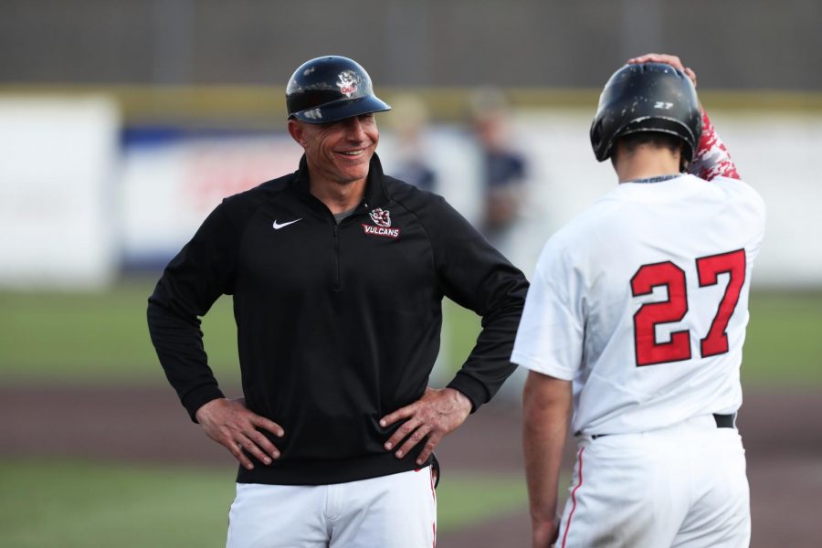 Cal U Head Baseball Coach Mike Conte talks to a player at a home game versus UPJ at Washington Wild Things Park on April 6, 2019.