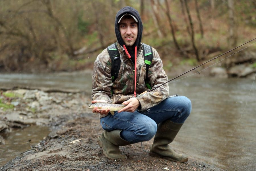 Michael Goga, fisheries & wildlife major, Cal U, displays a trout he caught before releasing it back into the waters of Pike Run, California, Pa. on April 7, 2020, the first official day of trout season.