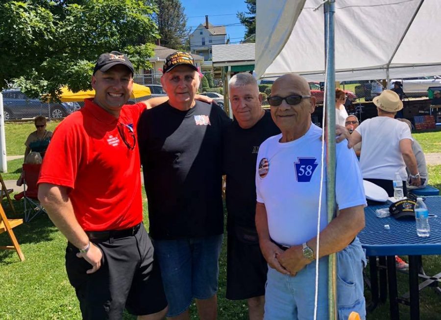 A gathering of military veterans (from left) Robert Prah, Jr., Bill Callaway, Jim Gardner, and Prahs grandfather, Nunzio Santo Colombo, at a Veterans appreciation picnic at Community Bank Park in North Belle Vernon, June 2019.