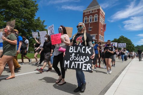 Hundreds march past the Booker Towers at California University of Pennsylvania in a