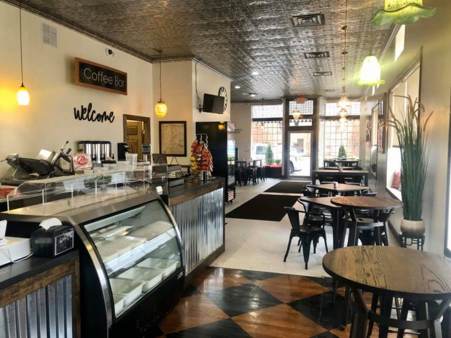 Interior of The Sandwich Shop and Deli. Menu items include antipasta salad, the all American hoagie, and hot buffalo chicken bagels.