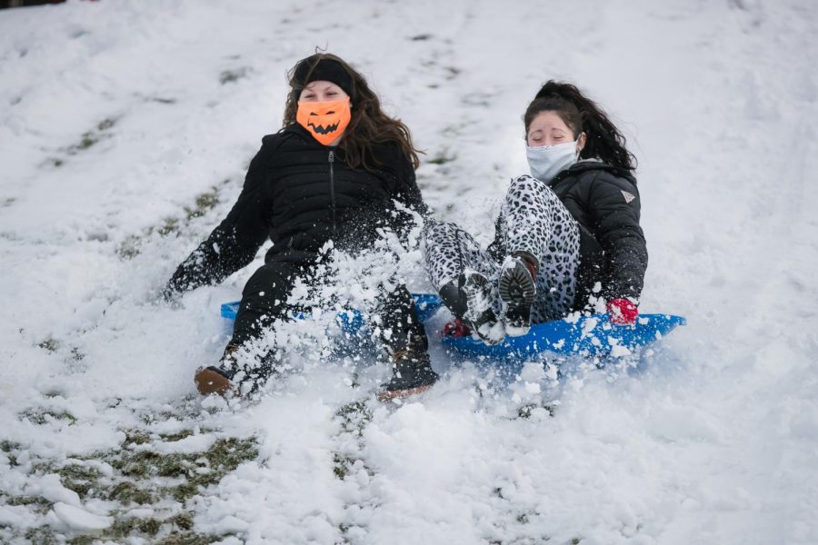 Cal U students sled riding the hills along Hickory Street near campus on Monday, Feb. 1, 2021