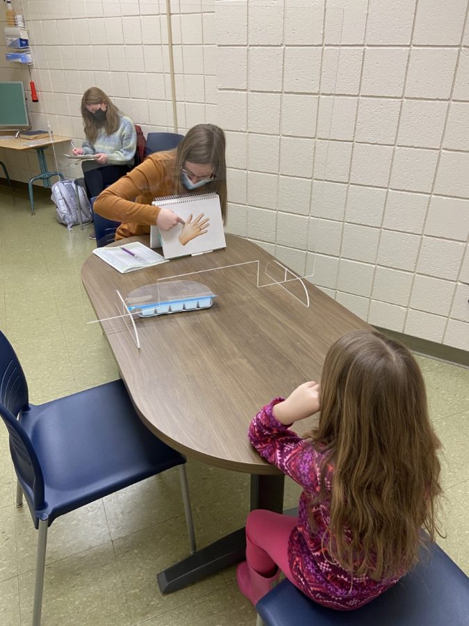 A transparent window mounted on the tabletop at the speech-language and hearing clinic in Morgan Hall serves as a protective barrier to help prevent the spread of novel coronavirus (COVID-19).