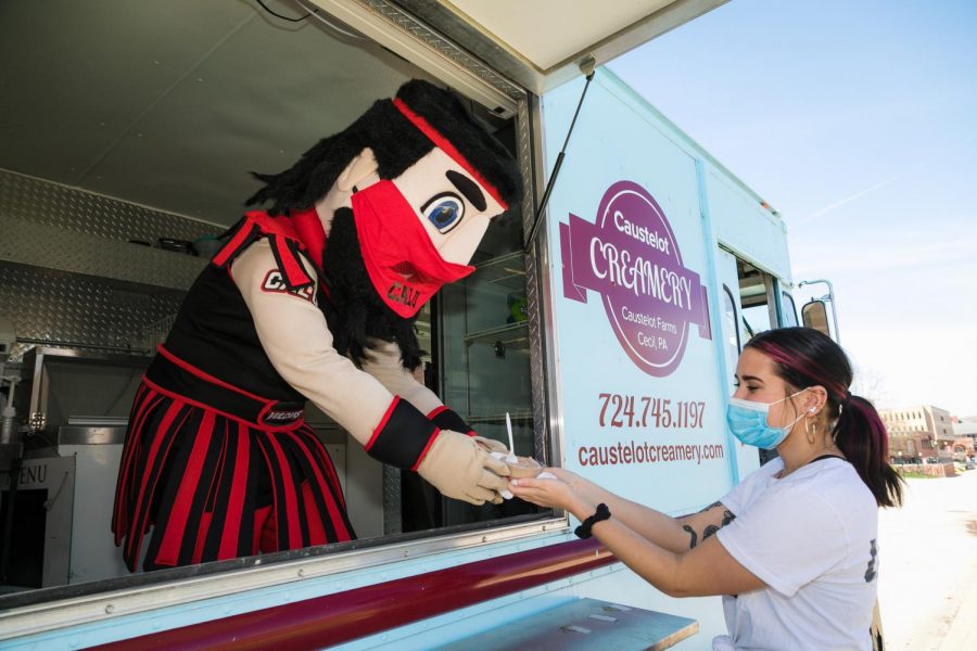 Cal U Vulcans mascot Blaze offers ice cream to Amanda Considine, president, Student Government Association, from the Caustelot Creamery truck on campus for Mental Health Awareness Days on March 30, 2021.