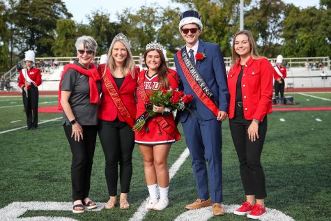 University President Dr. Dale-Elizabeth Pehrsson, joins, from left, 2019 homecoming co-queen Maddie Rush, 2021 queen Christina Hebda, 2021 king Zachary Snedeker and SGA President Caitlyn Urban at midfield during the Cal U homecoming football game.