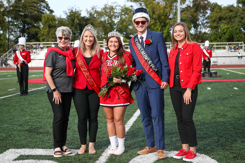 University President Dr. Dale-Elizabeth Pehrsson, joins, from left, 2019 homecoming co-queen Maddie Rush, 2021 queen Christina Hebda, 2021 king Zachary Snedeker and SGA President Caitlyn Urban at midfield during the Cal U homecoming football game.