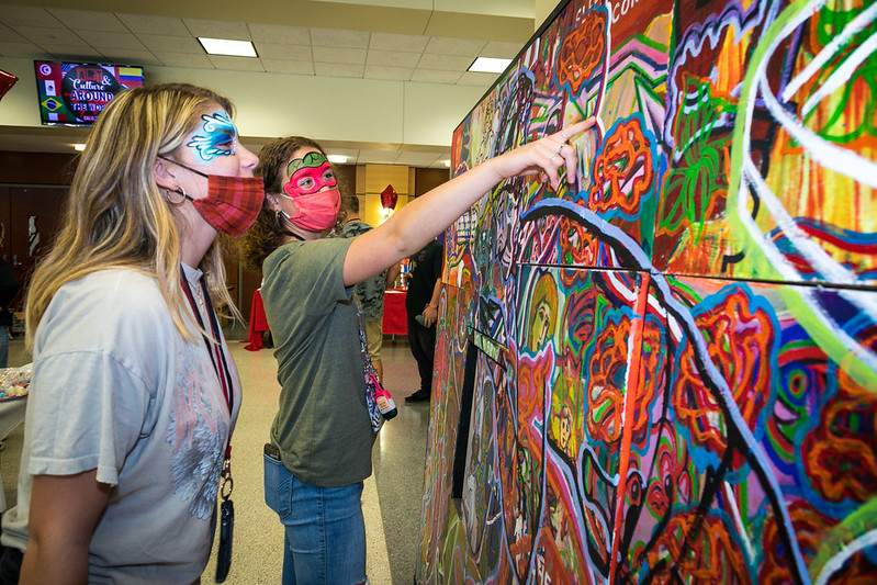 Delaney Ruth and Meghan Hartley, students at California High School, admire the artwork by Cal U professor Todd Pinkham on display at the annual Liberal Arts Festival, Convocation Center, Oct. 5, 2021.