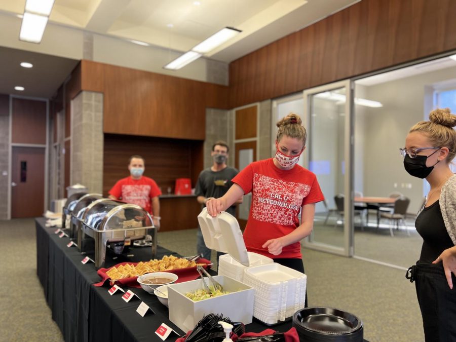 Cal+U+student+gets+ready+to+pass+out+spaghetti+dinner+to+attendees.+