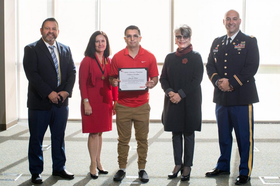 Juan Bueno (center), senior psychology major and former U.S. Marine Corps sergeant, is the recipient of the 2021-22 Colonel Arthur L. Bakewell Scholarship.  (From left) T. David Garcia, vice president of enrollment management and U.S. military veteran, Cherie Sears, daughter of Col. Bakewell, Juan Bueno, Dr. Dale-Elizabeth Pehrsson, interim president, California University of Pennsylvania, Robert Prah, military and Veterans Affairs director/advisor, South Wing, Convocation Center, Nov. 10, 2021.  