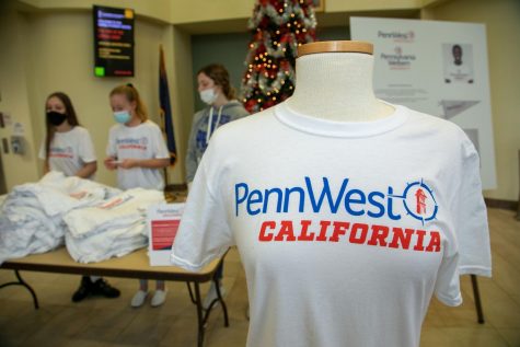 Cal U students Samantha Taylor, Abigail Farabaugh and Elizabeth Brudnock were at the table in the Natali Student Center handing out free t-shirts and stickers featuring the wordmark design for PennWest California, Dec. 2, 2021