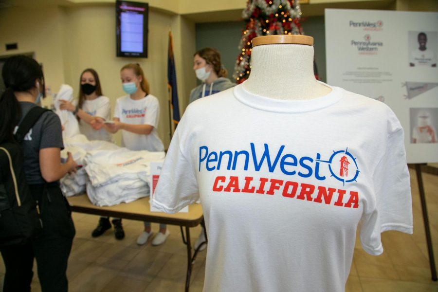 Free T-shirts and stickers featuring the new PennWest logo design were available for students in the Natali Student Center, Dec. 2, 2021. (Photo: Jeff Helsel / Cal Times)