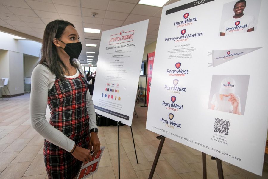 Cal U student Destiny Brooks looks at the display of proposed logos of Pennsylvania Western University, the integrated university of California, Clarion and Edinboro on Oct. 19, 2021. (Jeff Helsel / Cal Times).
