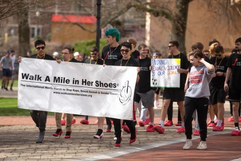 Men march on Cal Us campus to raise awareness around domestic violence and sexual assault on April 12, 2022. 
