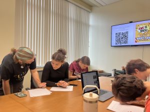 Writers in AWE's journalism workshop writing news articles at PennWest California.