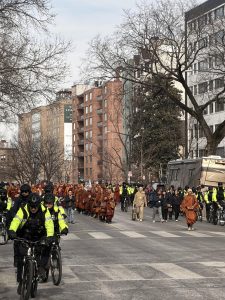 Police officers on bicycles as the monks continued their walk, guarding them from potential disruptions or attacks.
