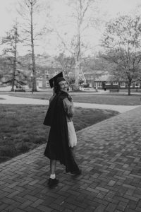 One of my graduation photos, where I symbolically hold my regalia over my shoulder and face the future.